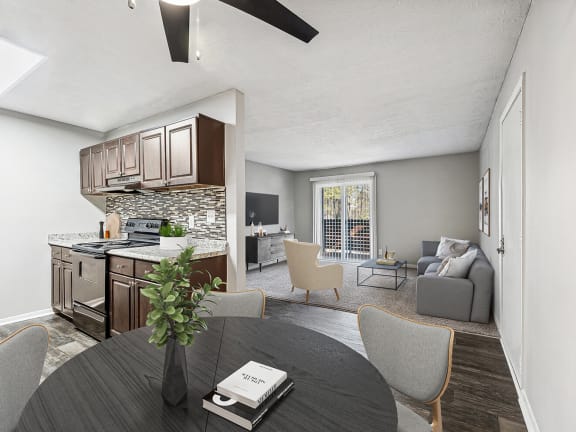 Model Dining Room with Wood-Style Flooring and View of Kitchen at Paramont Apartments in Duluth, GA-LRGAM.