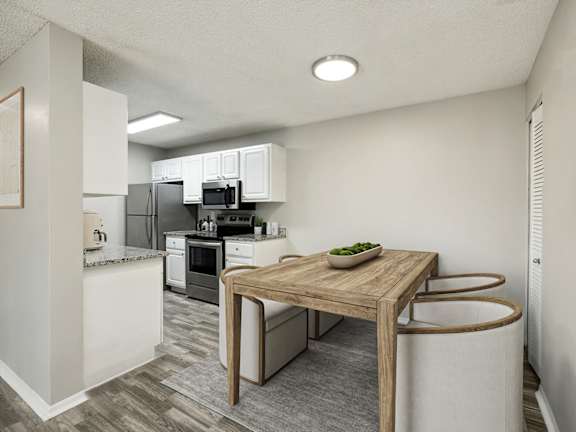 Model Kitchen with White Cabinets and Wood-Style Flooring at Arbors at Orange Park Apartments located in Orange, Park FL-LRGAM.