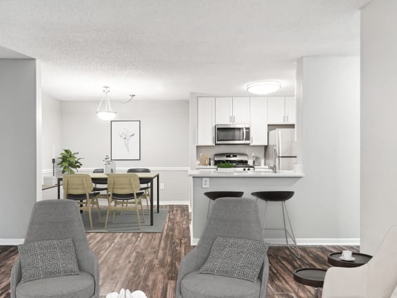 Model Dining Room with Wood-Style Flooring and View of Kitchen at Commons at Haynes Farm Apartments in Shrewsbury, MA-LRGAM.