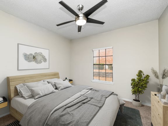 Model Bedroom with Carpet and Window View at Dallas North Park Apartments in Dallas, TX-LRGAM.