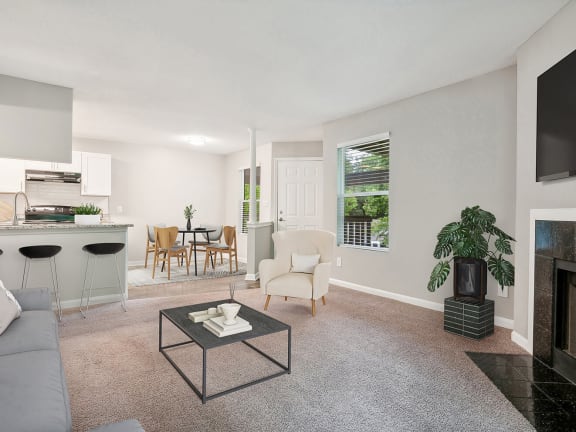 Model Living Room with Carpet, Fireplace and View of Kitchen at Park 2300 Apartments in Charlotte, NC-LRGAM.