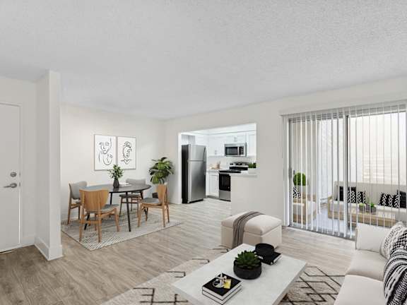 Model Living Room with Wood-Style Flooring and Patio Accessibility at Horizon Apartments located in Santa Ana, CA-LRGAM.