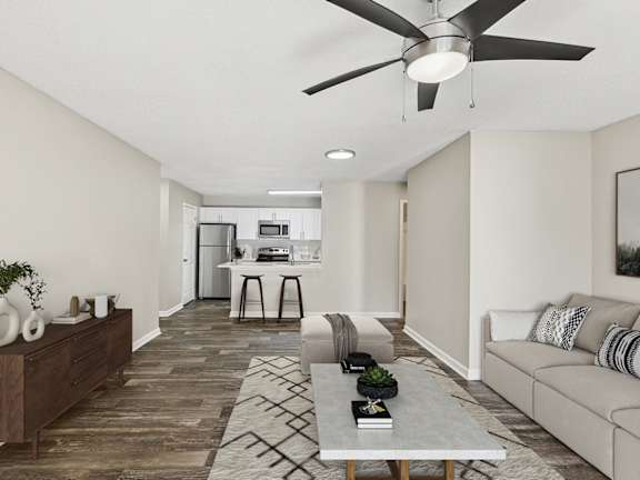 Model Living Room with Wood-Style Flooring and View of Kitchen at Element 41 Apartments located in Marietta, GA-LRGAM.