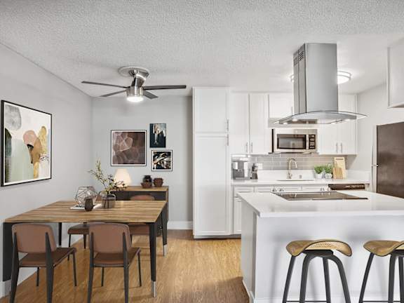 Model Kitchen with White Cabinets and Wood-Style Flooring at Cove La Mesa Apartments located in La Mesa, CA-LRGAM.