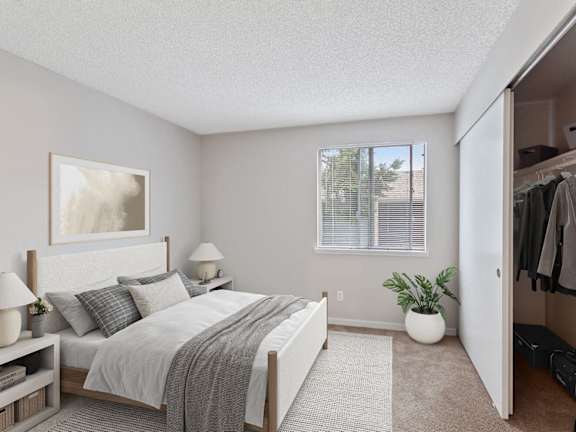 model bedroom with carpet and closet