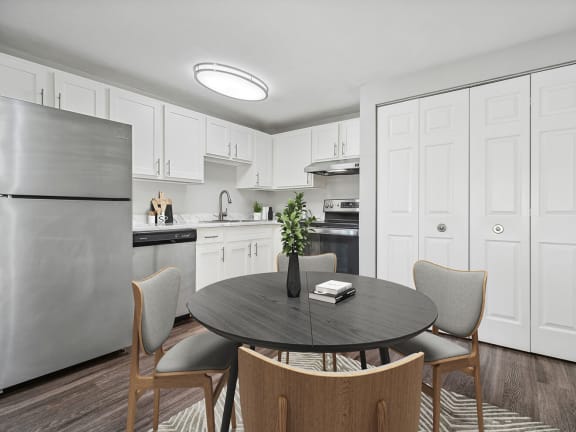 Model Kitchen with White Cabinets and Wood-Style Flooring at Village at Marshfield Apartments located in Marshfield, MA-LRGAM.