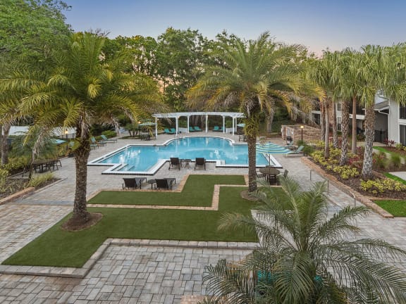 Community Swimming Pool with Pool Furniture at Grand Pavilion Apartments in Tampa, FL-LRGAM.