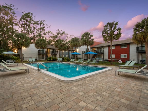 Community Swimming Pool with Pool Furniture at Heron Walk Apartments in Jacksonville, FL-LRGAM.