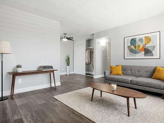Model Living Room with Wood-Style Flooring at Accent on Rainbow Apartments located in Las Vegas, Nevada.