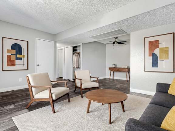 Model Living Room with Wood-Style Flooring at Accent on Rainbow Apartments located in Las Vegas, Nevada.