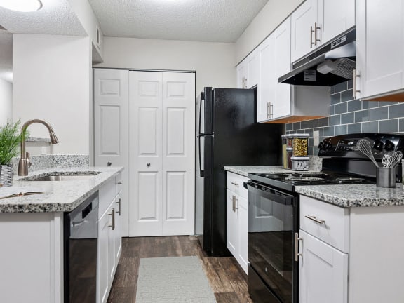 Model kitchen with black appliances at Park 2300 Apartments in Charlotte, North Carolina