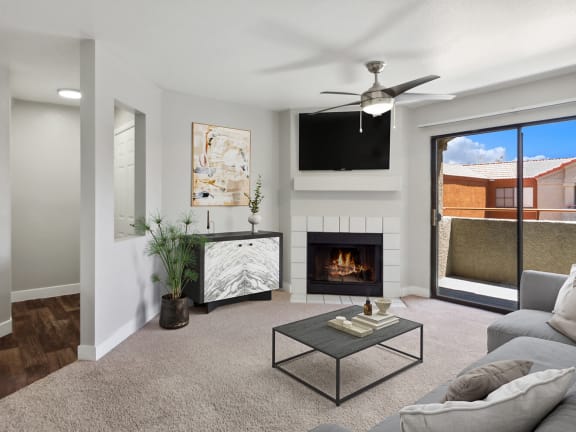 Model Living Room with Carpet, Fireplace and Patio Accessibility at Stonegate Apartments located in Las Vegas, NV-LRGAM.