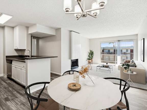 Model Dining Room with Wood-Style Flooring at Madison Park Apartments located in Anaheim.