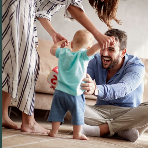 A man and a child are playing together on the floor.