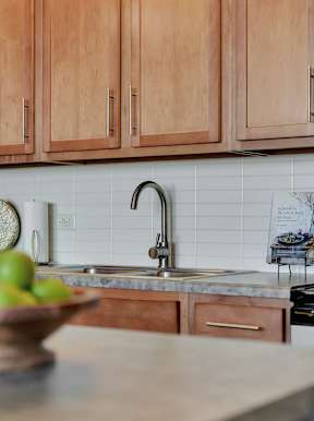 a kitchen with wooden cabinets and a sink at Parkhaus Apartments, Lincoln, 68508