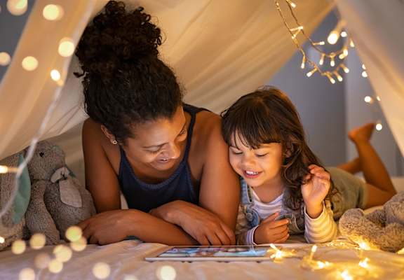 Mom and daughter reading in fort at Rocket Transfer Lofts, Des Moines, 50309