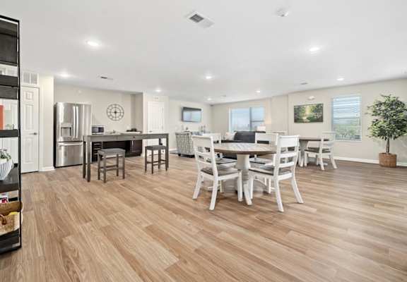 a kitchen and dining room with a table and chairs
