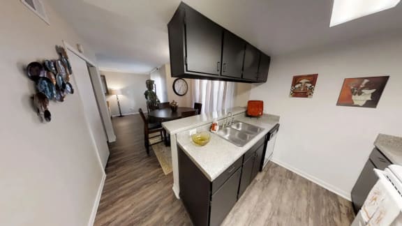 a kitchen with a sink and a table in a room