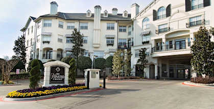 a large white building with a sign in front of it