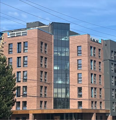 A housing corporation advertisement for affordable units with a call to action to apply today.