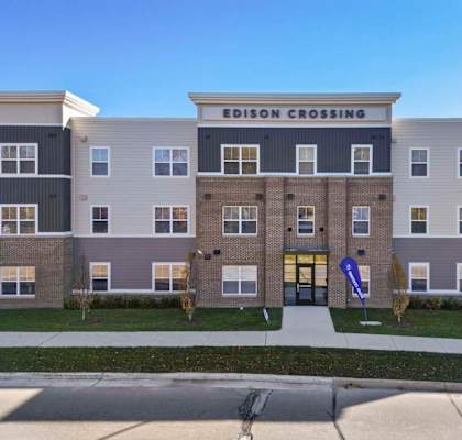an image of a building with a sidewalk in front of it