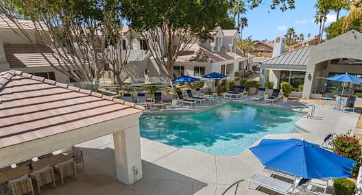 A pool with a slide and a hot tub.