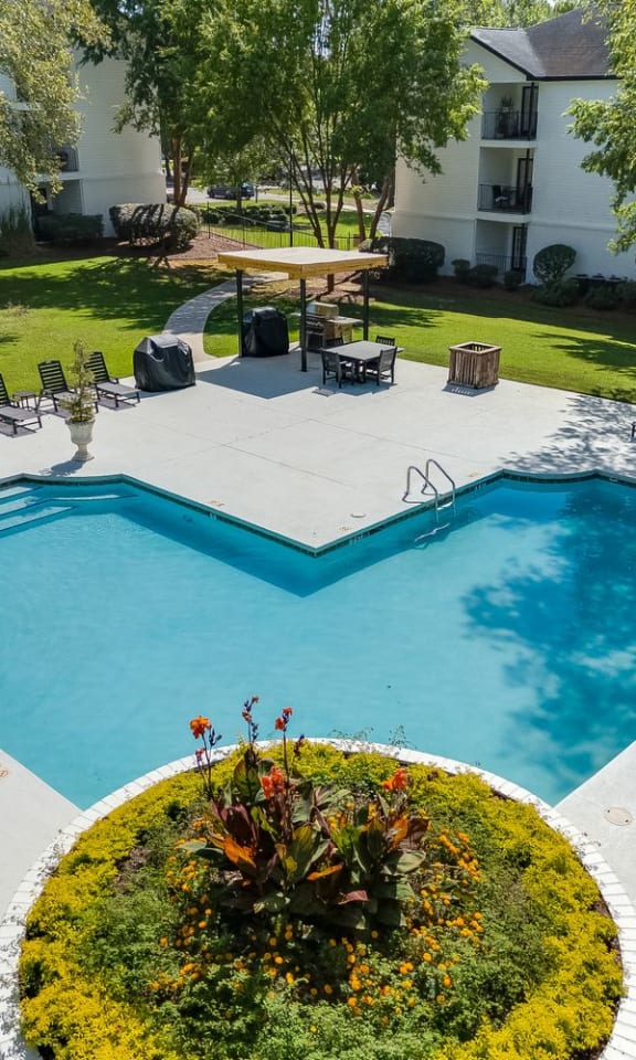 an aerial view of a swimming pool and patio with chairs and trees at Dothan Farms, Dothan, AL, 36305