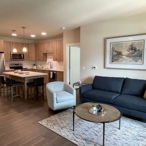 a living room and kitchen apartment in Middleton, WI with a couch and a table