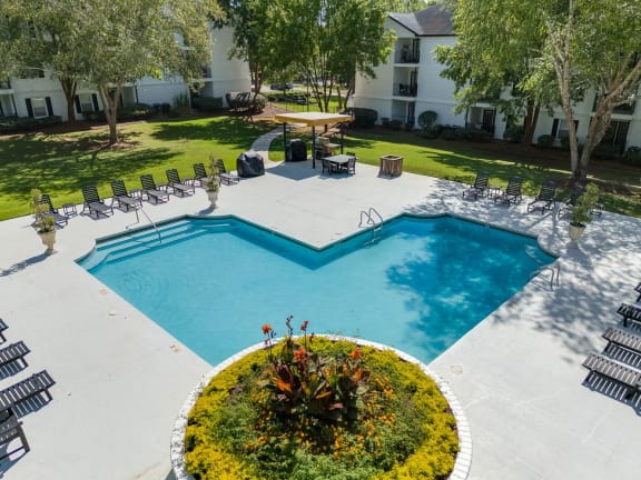 an aerial view of a swimming pool and patio with chairs and trees at Dothan Farms, Dothan, AL, 36305