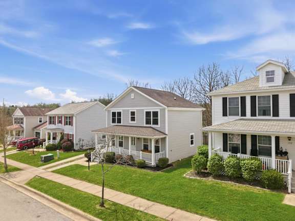 A row of houses with a clear blue sky above them.
