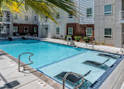 Thumbnail 14 of 42 - A swimming pool surrounded by a metal railing and a building in the background. 605 Place Student Housing & Co-Living, St George