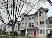 Thumbnail 7 of 8 - Apartment building with a sign that says "Now Leasing".