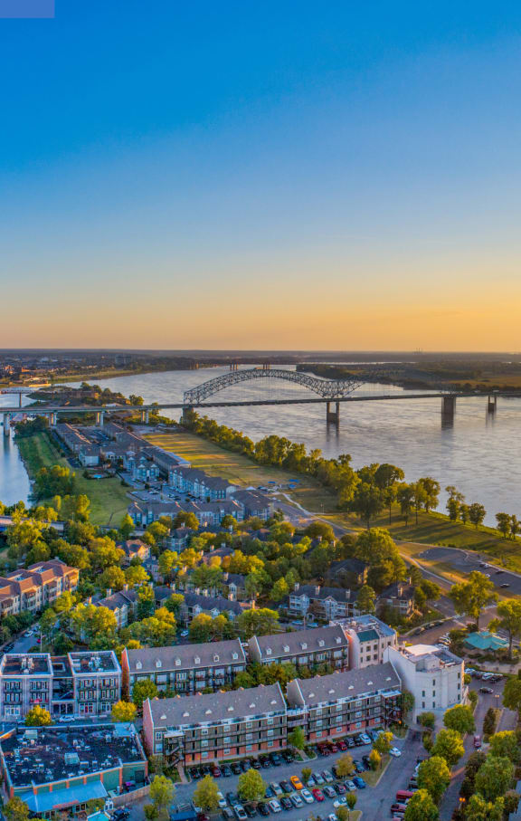 an aerial view of a city with a river and a bridge
