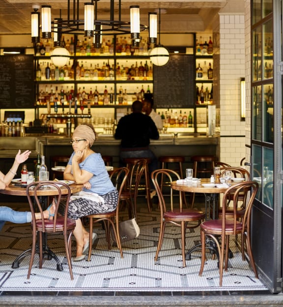a woman sitting at a table in a restaurant