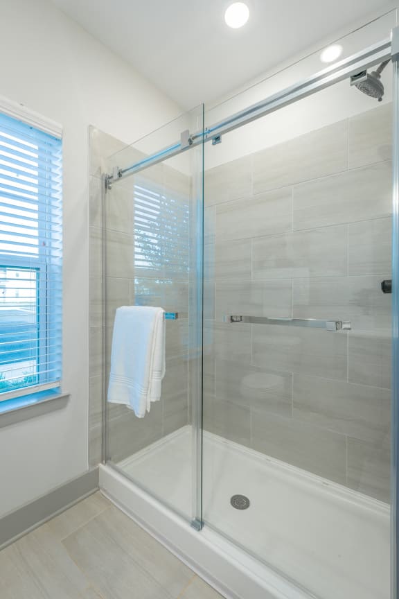 a shower with a glass door in a bathroom