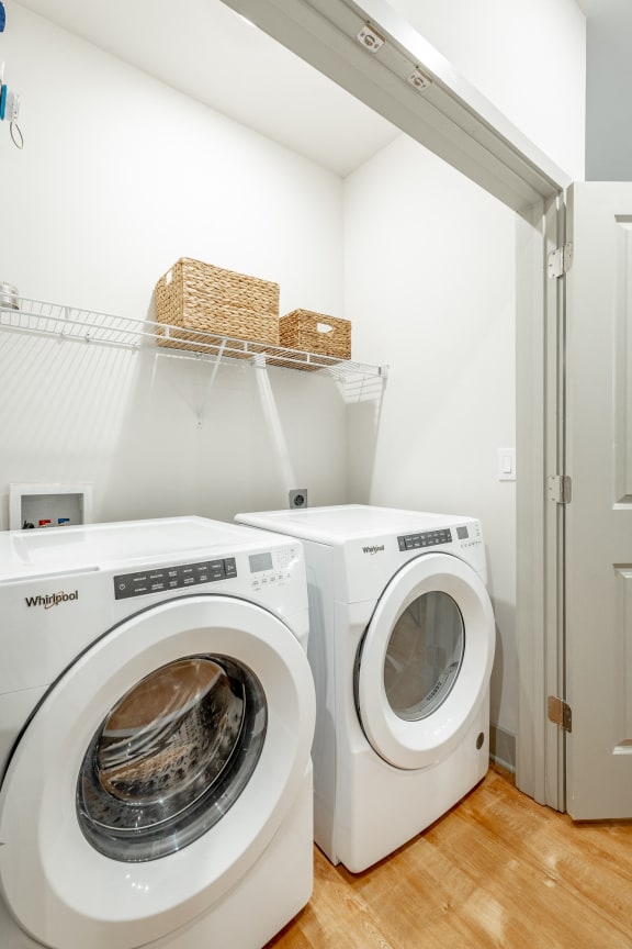 a washer and dryer in a laundry room with a closet