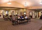 Thumbnail 11 of 11 - A large room with a table and chairs in the middle.