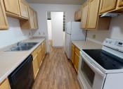 Thumbnail 8 of 19 - Kitchen with appliances and wooden shelves
