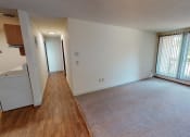 Thumbnail 9 of 19 - Hallway with kitchen on the left and living room on the right