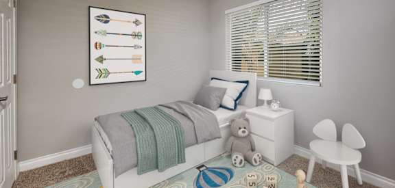 A child's bedroom with a white bed, a teddy bear, and a framed picture of arrows on the wall.