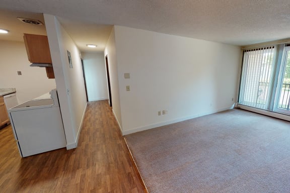 Hallway with kitchen on the left and living room on the right