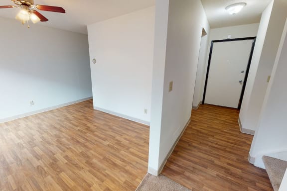 Dining room on the left and hallway on the right with wood flooring