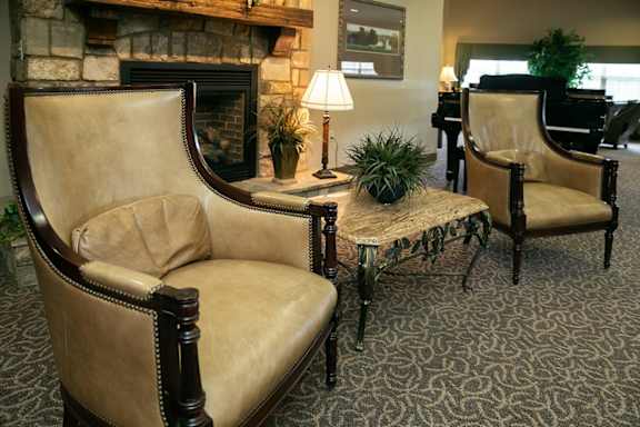 Two chairs and a table in a room.