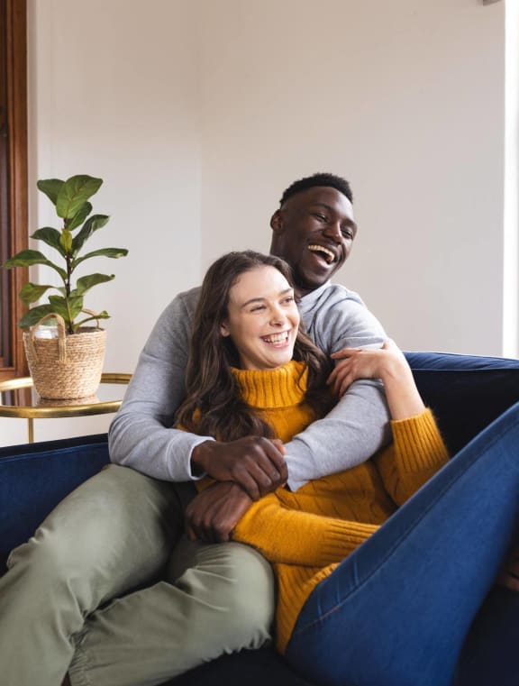 a man and a woman sitting on a blue couch