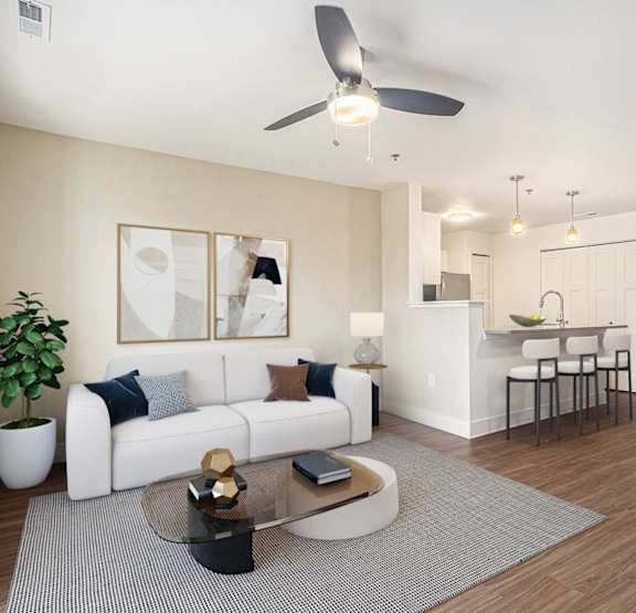 a living room with a couch and a ceiling fan  at Signature Pointe Apartment Homes, Athens