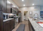 Thumbnail 15 of 24 - Kitchen with wooden cabinets at Seleno at Bridge Street, Huntsville, Alabama