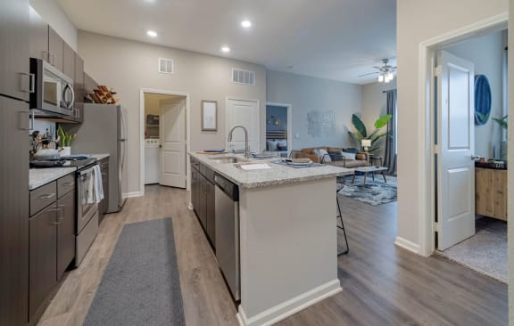 Kitchen with wooden cabinets and appliances at Seleno at Bridge Street, Huntsville, Alabama