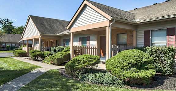A house with a grey roof and a brown fence.