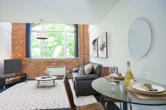 a living room with a couch and a table and a window