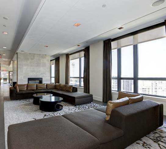 a living room filled with furniture and a large window